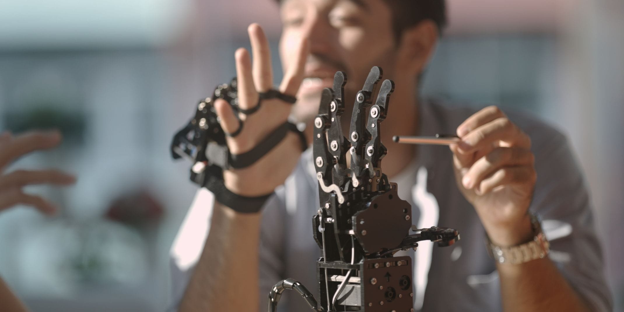 Engineers in training for the robotics industry. Engineer controlling robotic arm with technology