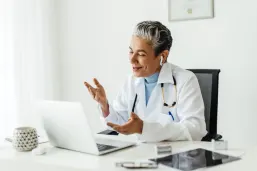 Mature female professor giving an online lecture on a video call