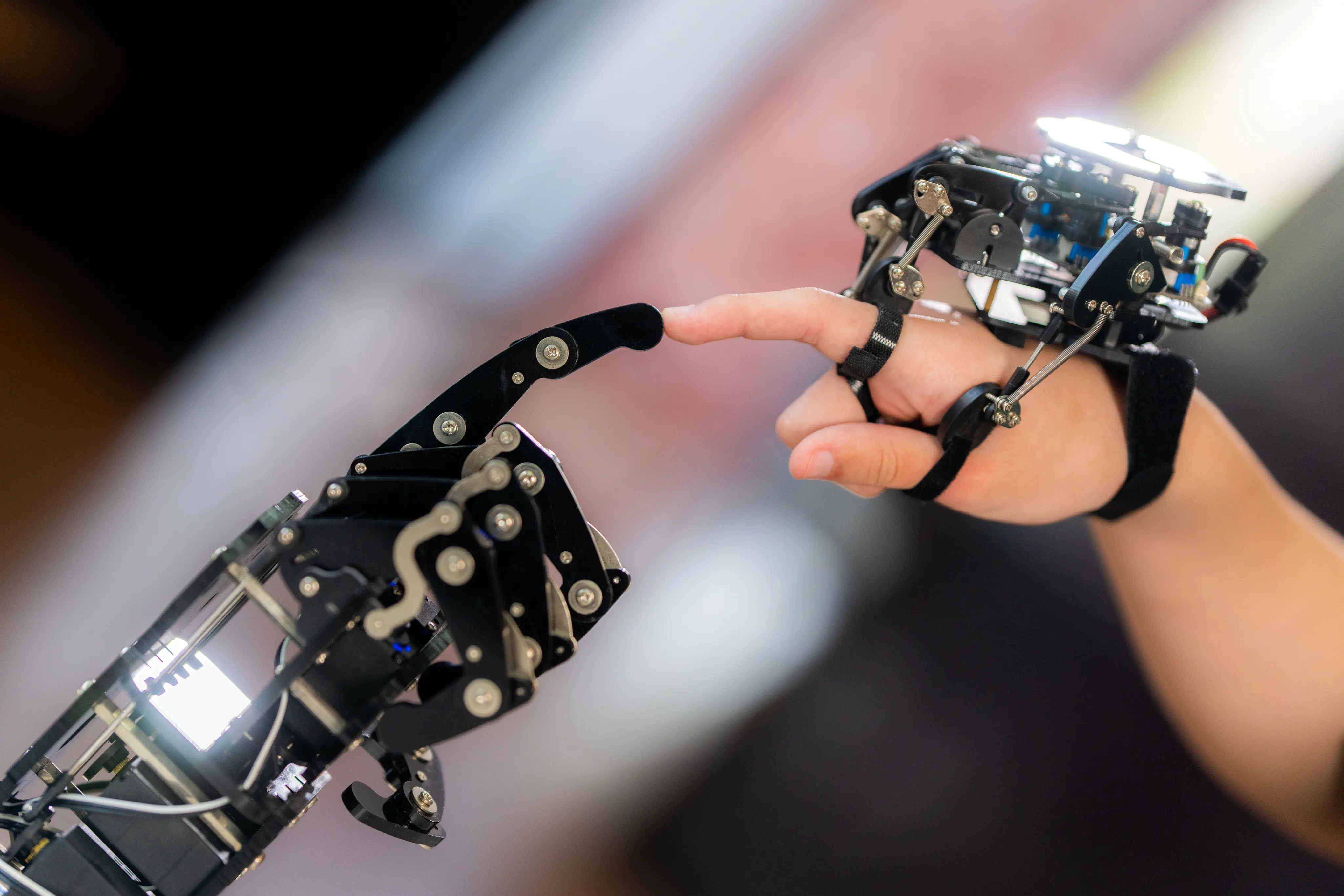 A boy learning to control his robotic arm