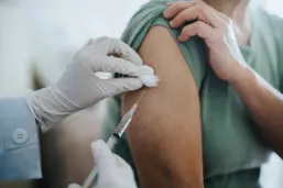 Close up of senior citizen getting a vaccine in arm