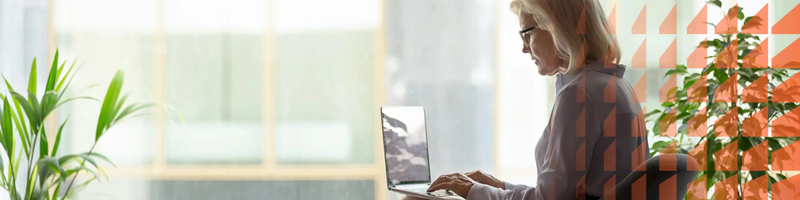 A woman looking in front of a laptop