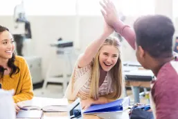 High school classmates high five each other