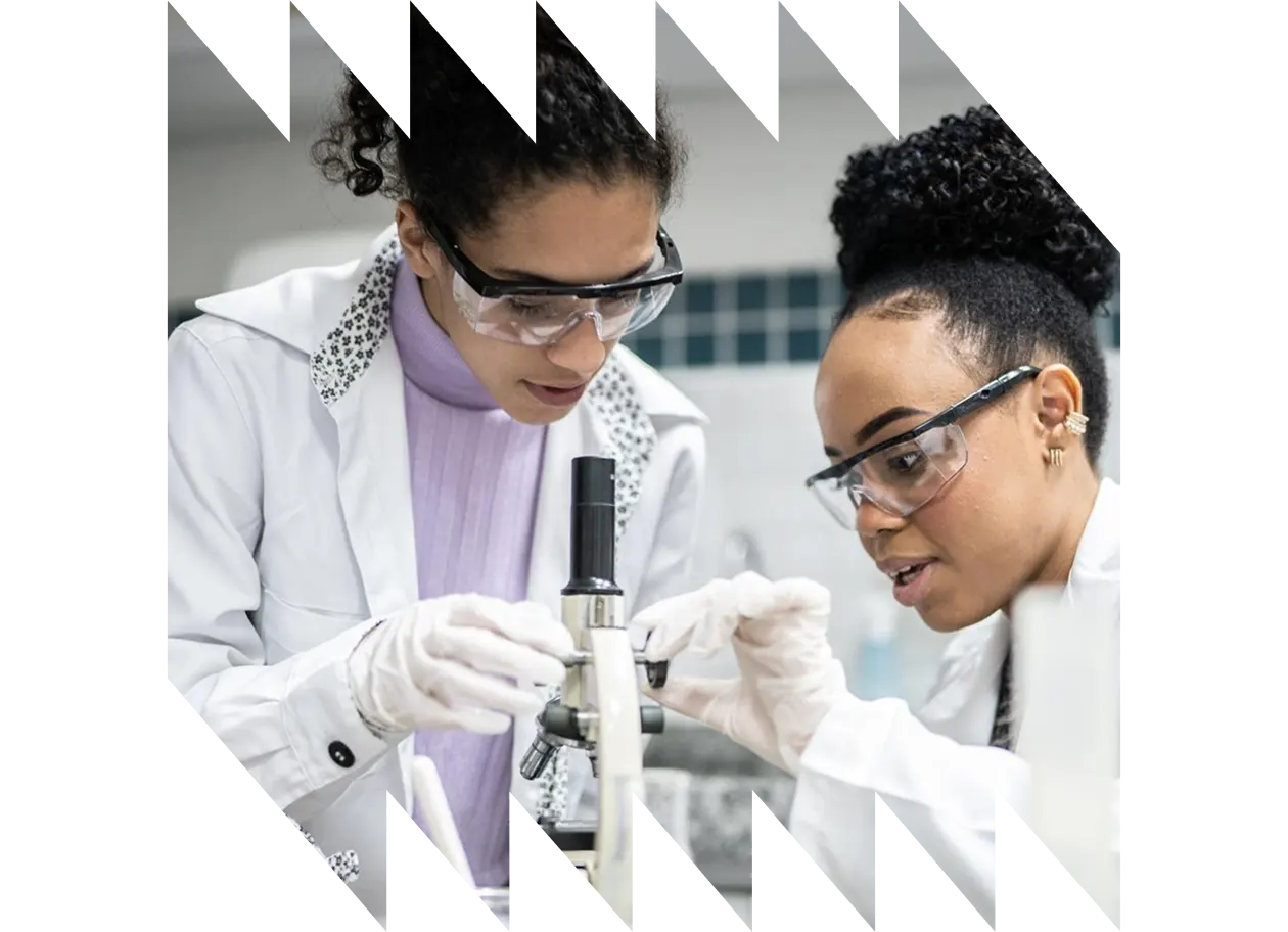 Close up of Young Asian scientist, wearing lab glasses and looking at a pipette