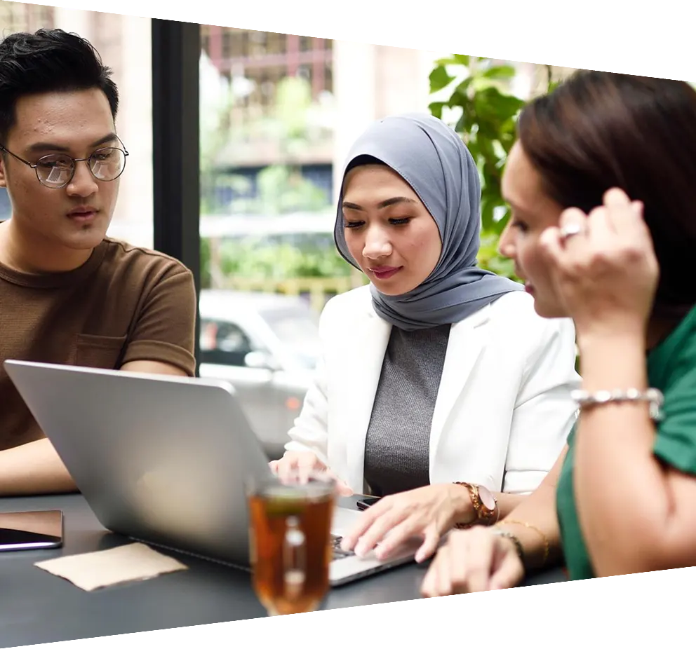 Three Malaysian colleagues having a business meeting outdoors
