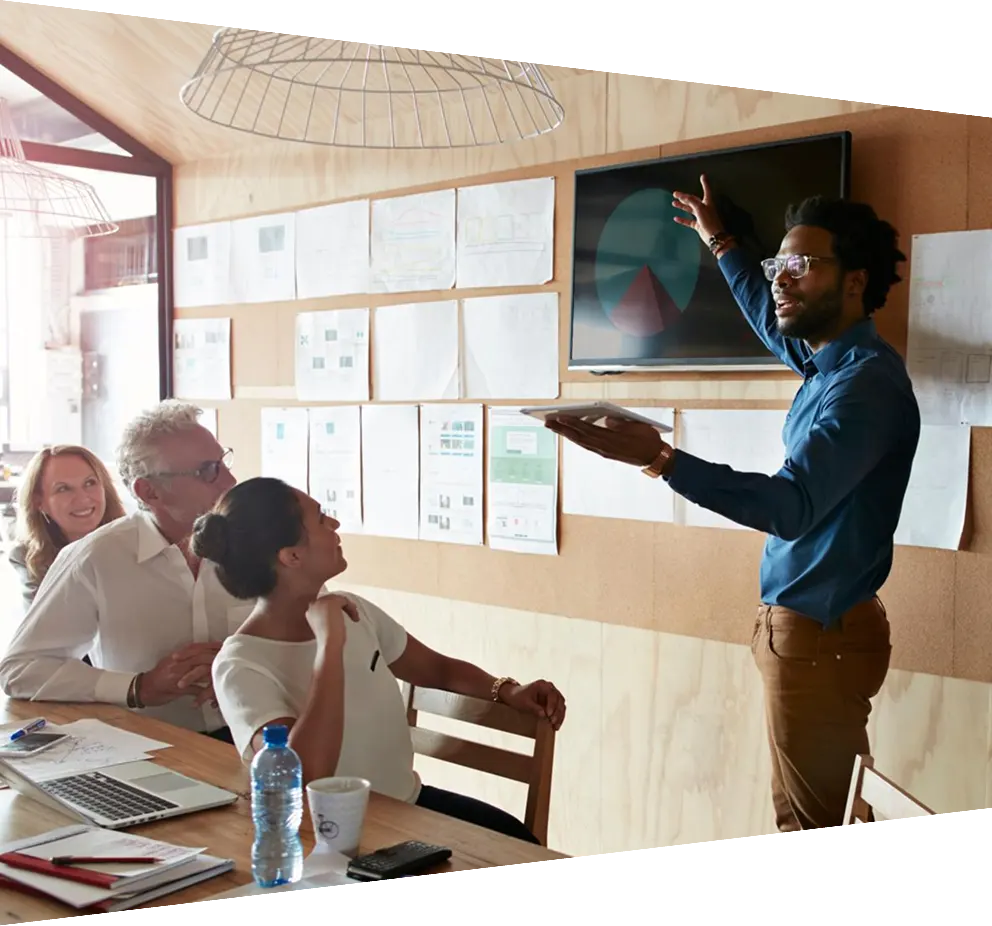 Man giving presentation, using tablet & screen