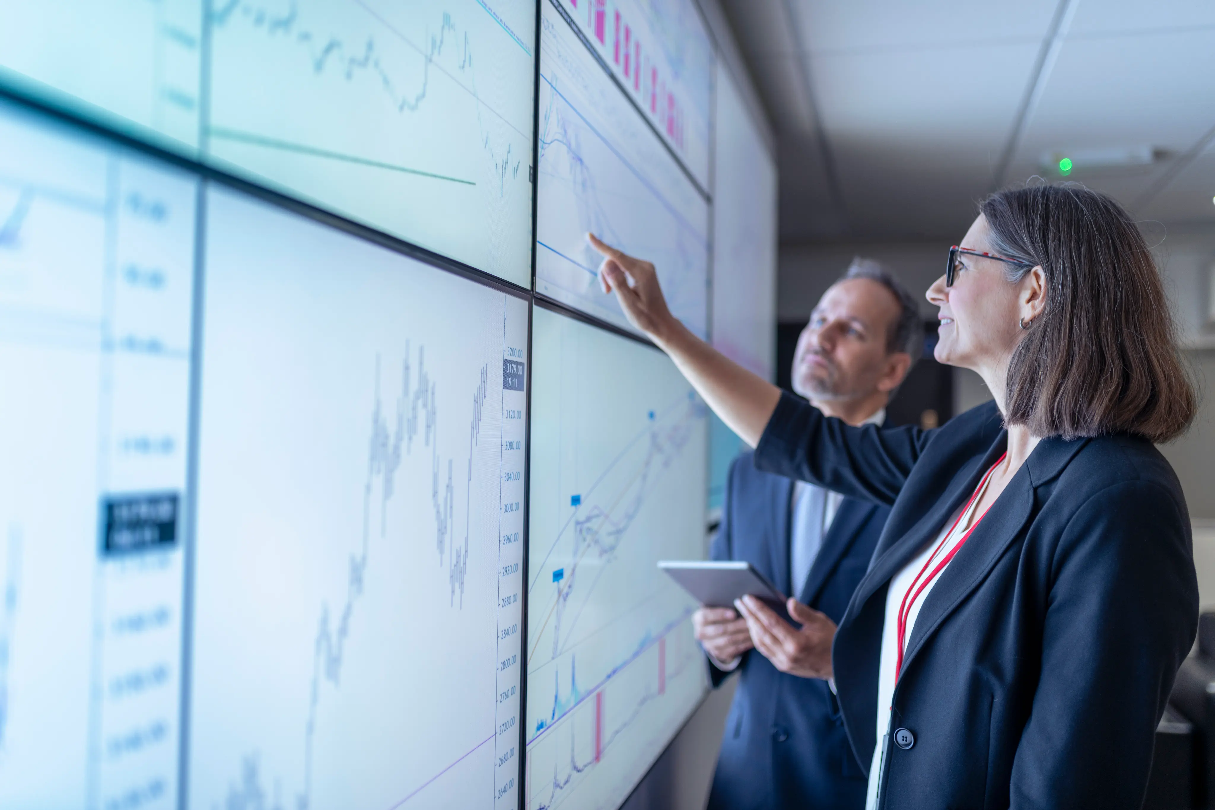 UK, York, Business people working with charts on interactive screens