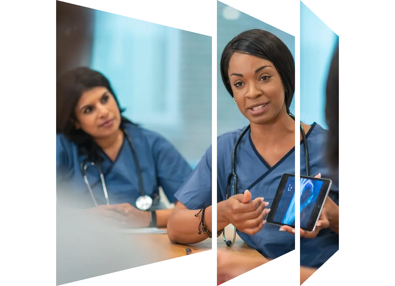 Medical professionals discussing over computer while working in clinic at hospital
