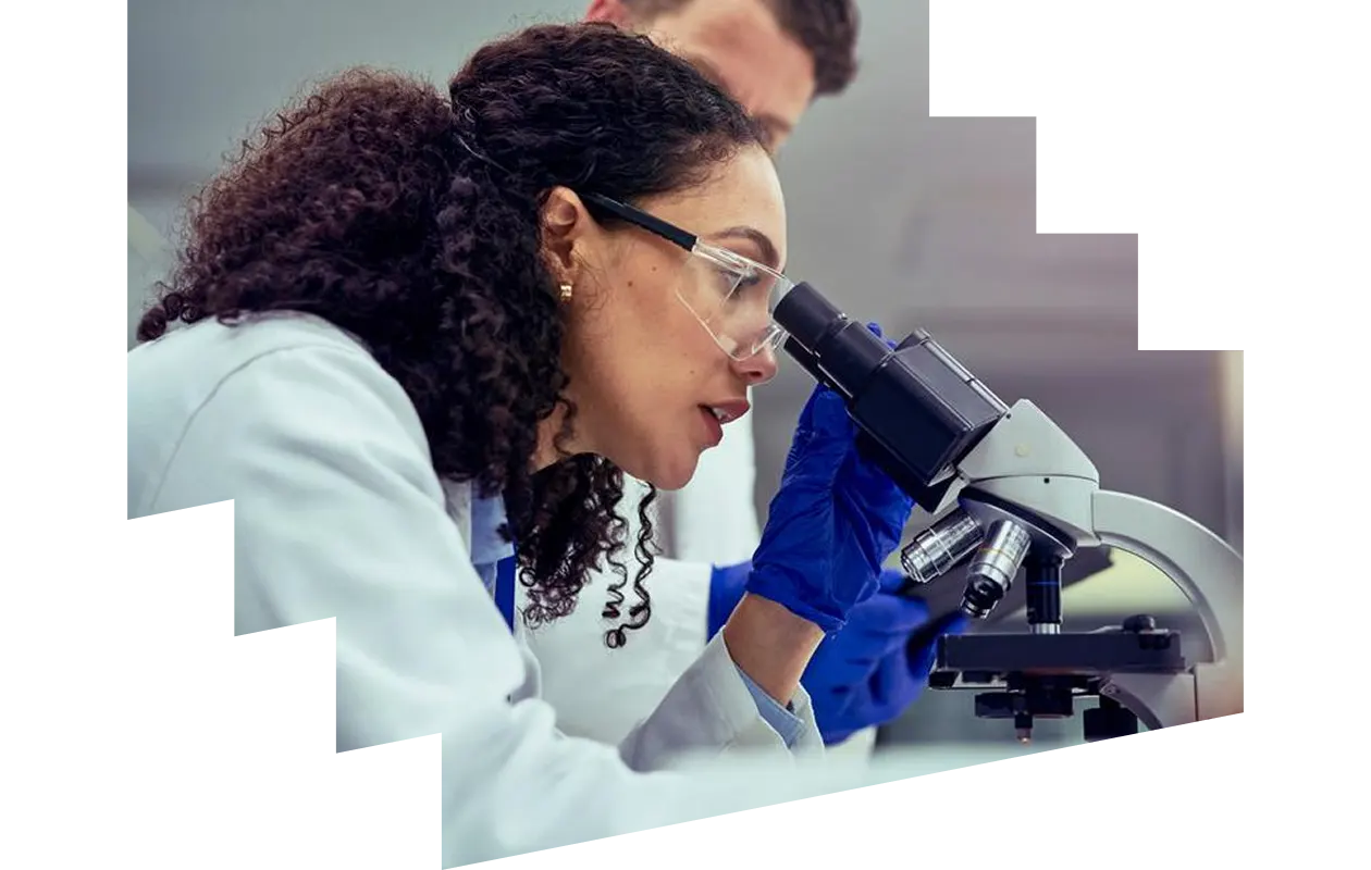 Clinician looking through microscope