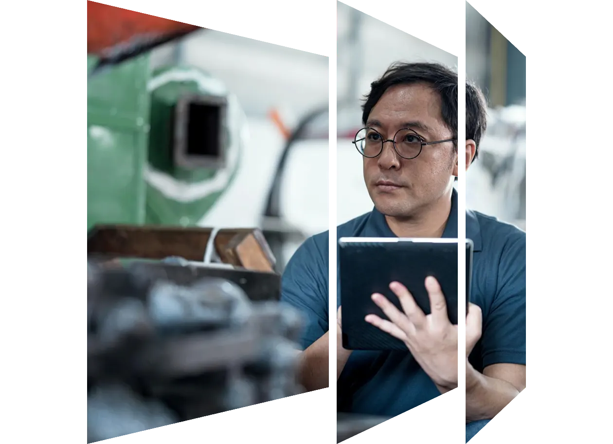 Senior maintenance engineer using machine monitoring software to improve production process