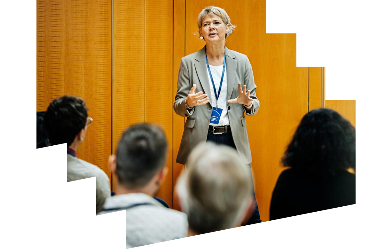Businesswoman giving presentation to conference participants