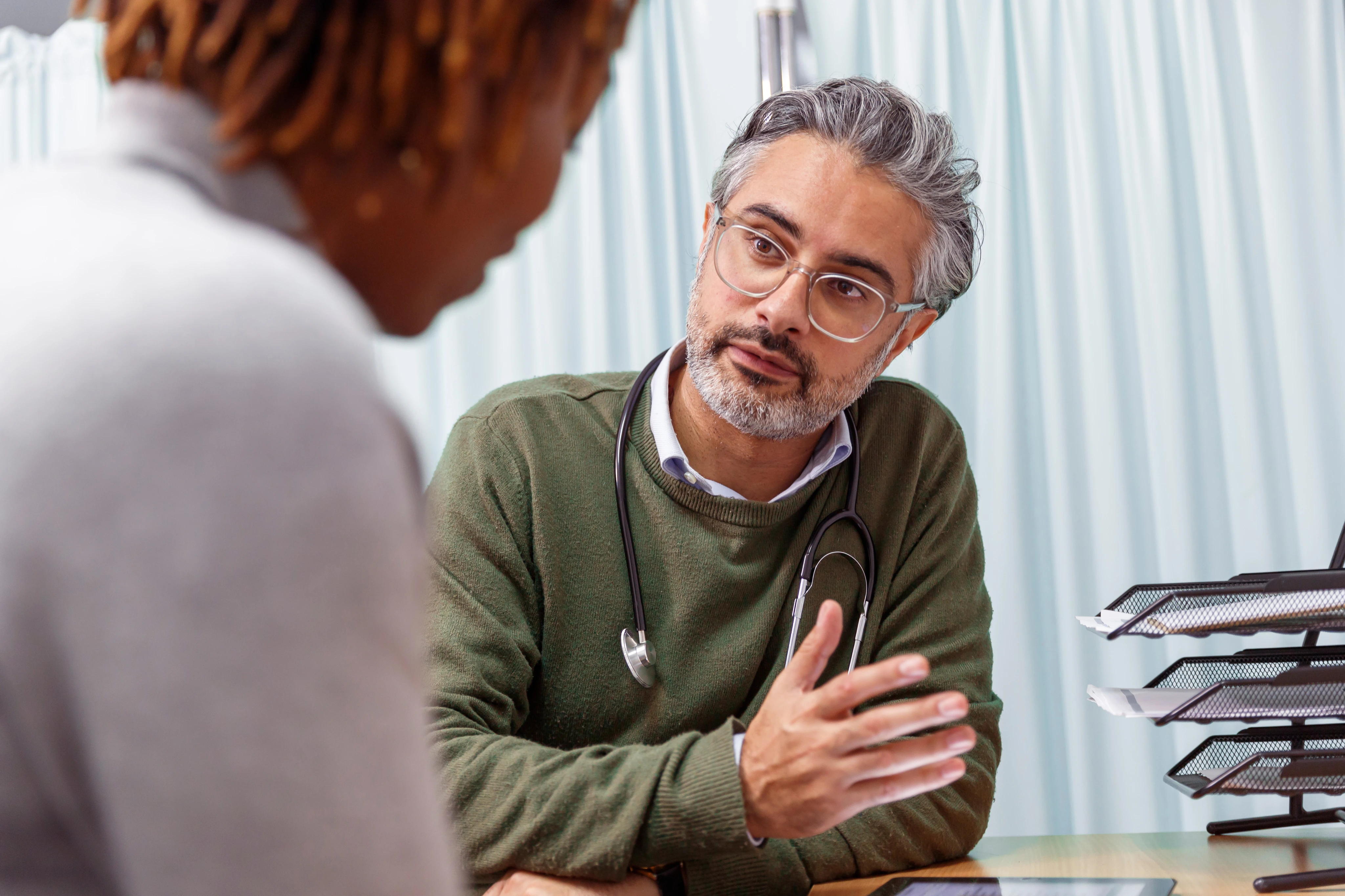 Doctor consulting patient in medical office