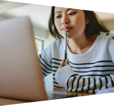 Young woman in a striped shirt staring at a computer