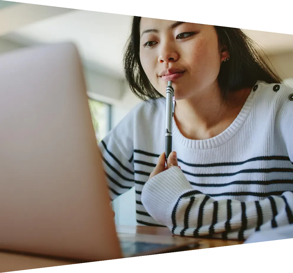 Young woman in a striped shirt staring at a computer