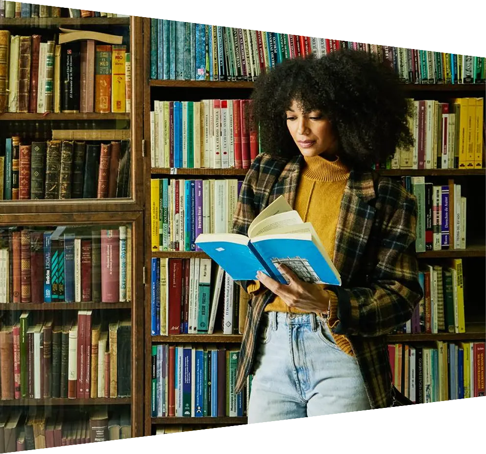 Young African-American Student Reading A Book In The Library