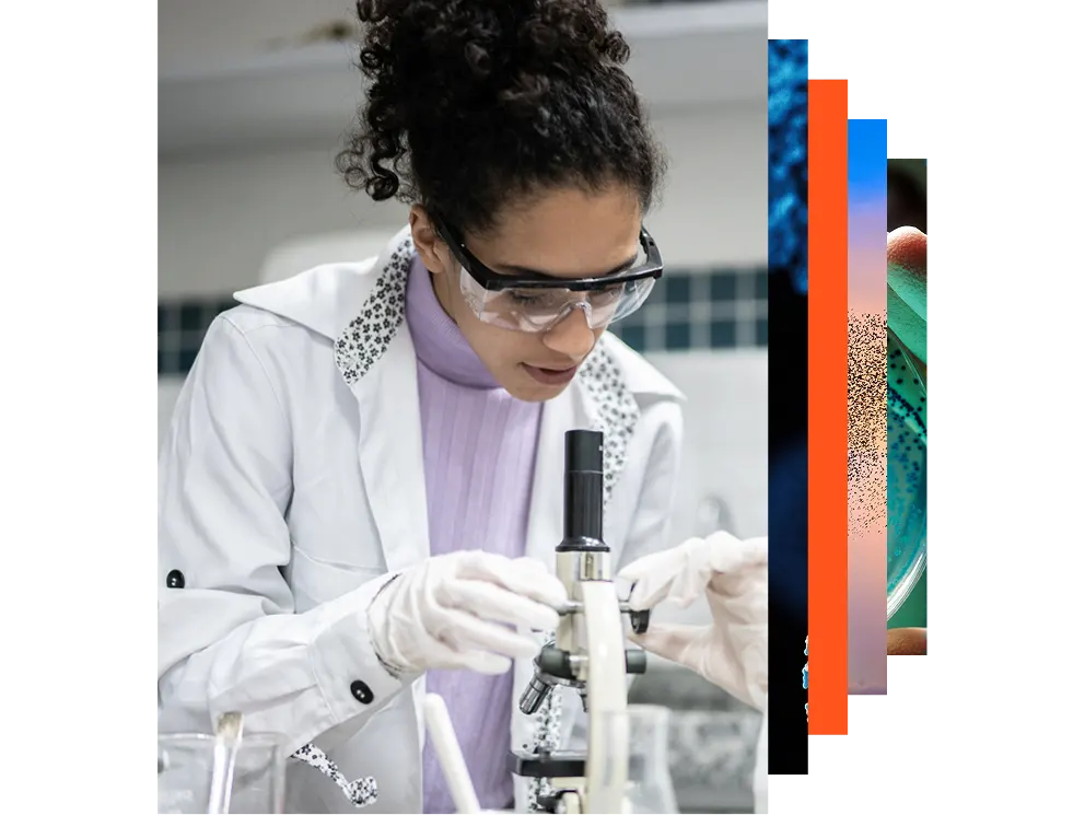 Young scientist looking through a microscope