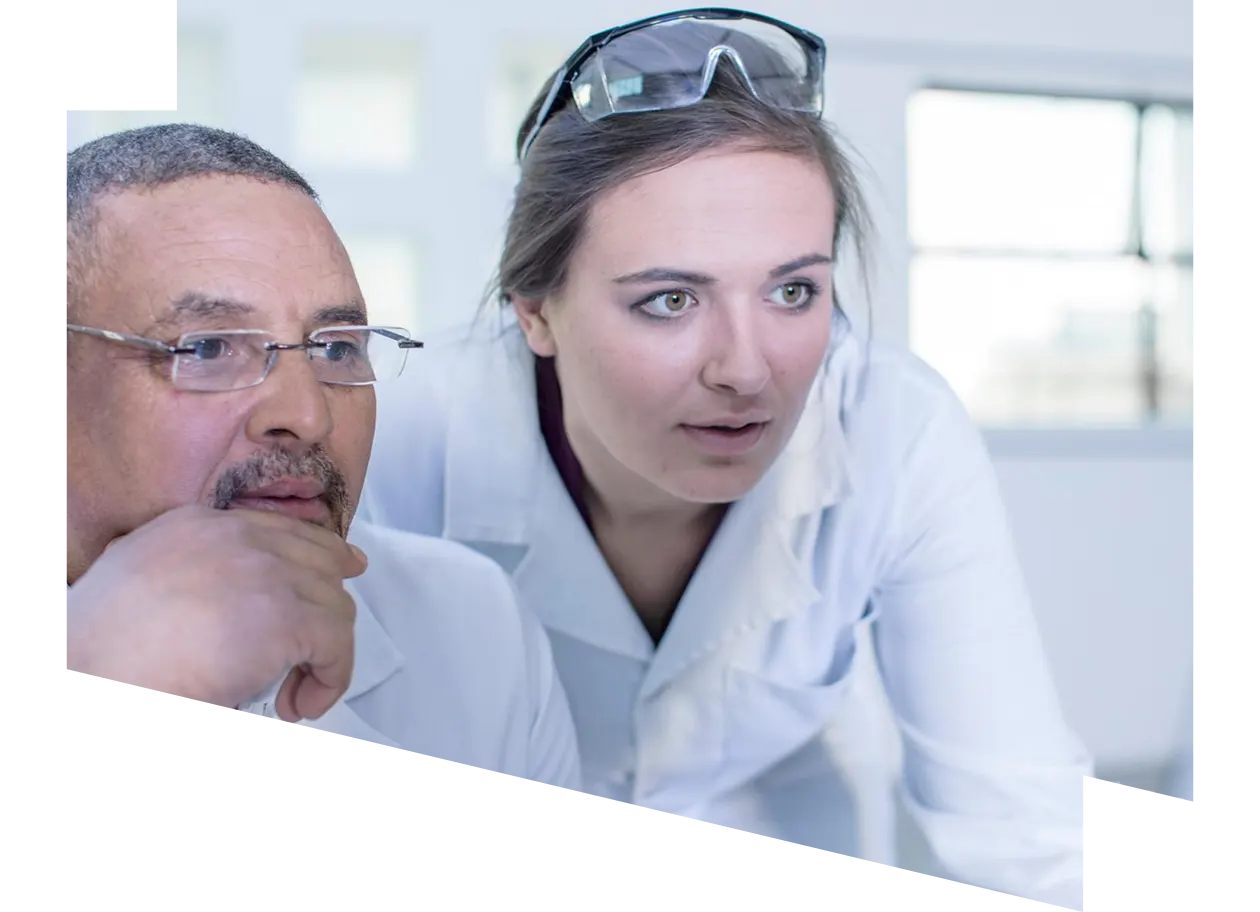 Two laboratory workers looking at computer screen