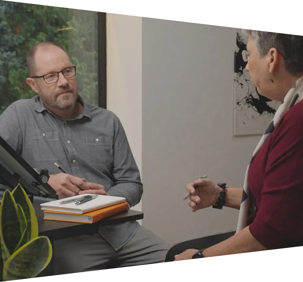 Two people sitting next to each other having a conversation