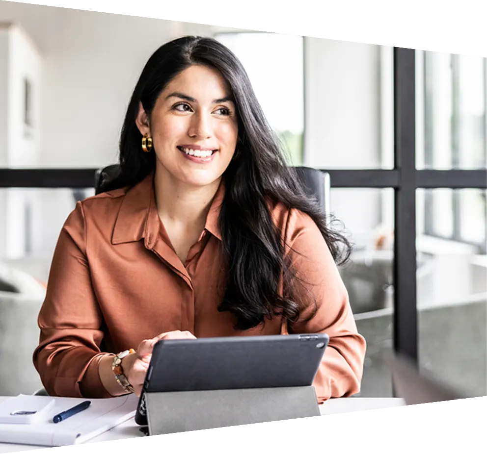 An Elsevier employee in a business suit and tie holds up her hand, making a peace sign with a confident smile.