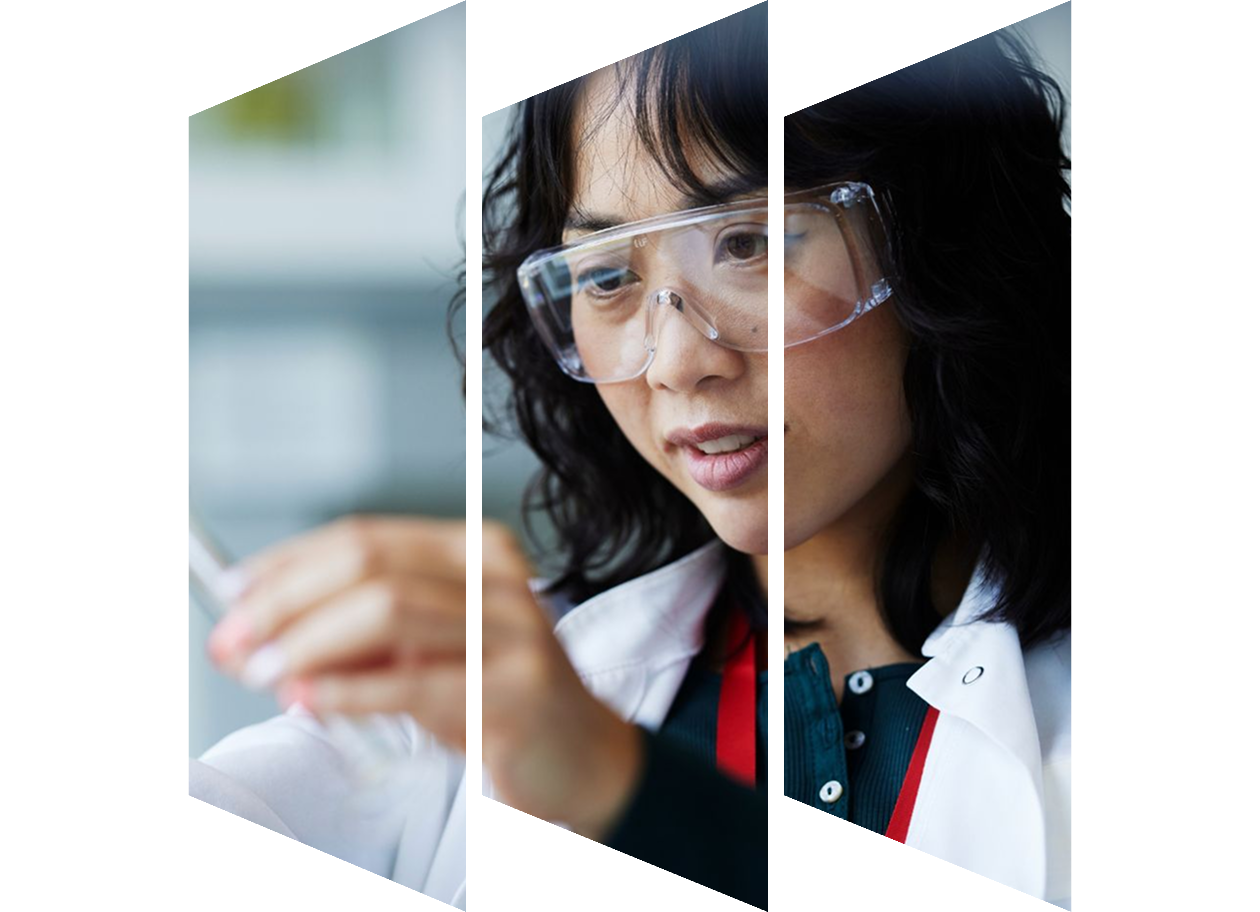 Close up of Young Asian scientist, wearing lab glasses and looking at a pipette