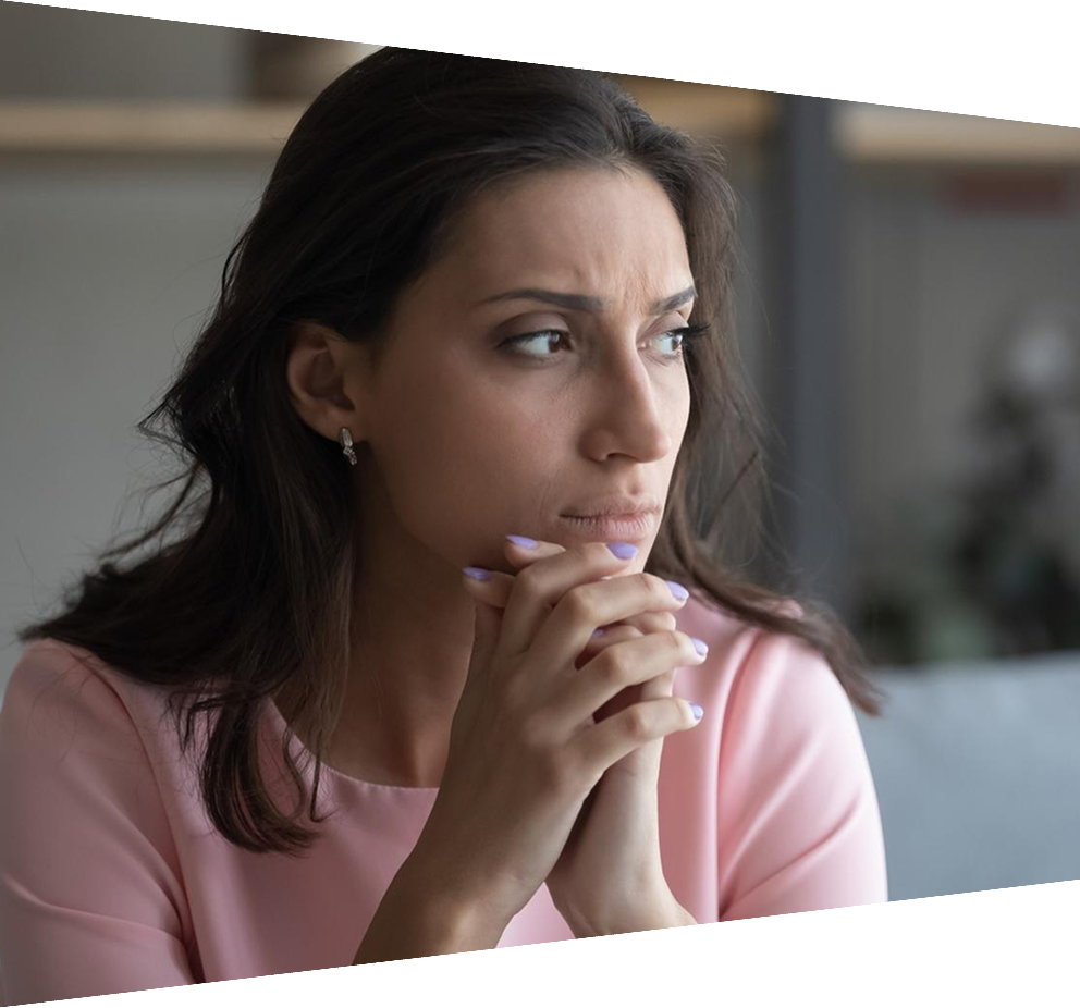 Anxious woman sitting on couch at home