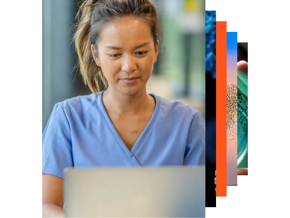 A woman in a lab coat stands with a laptop, ready to work