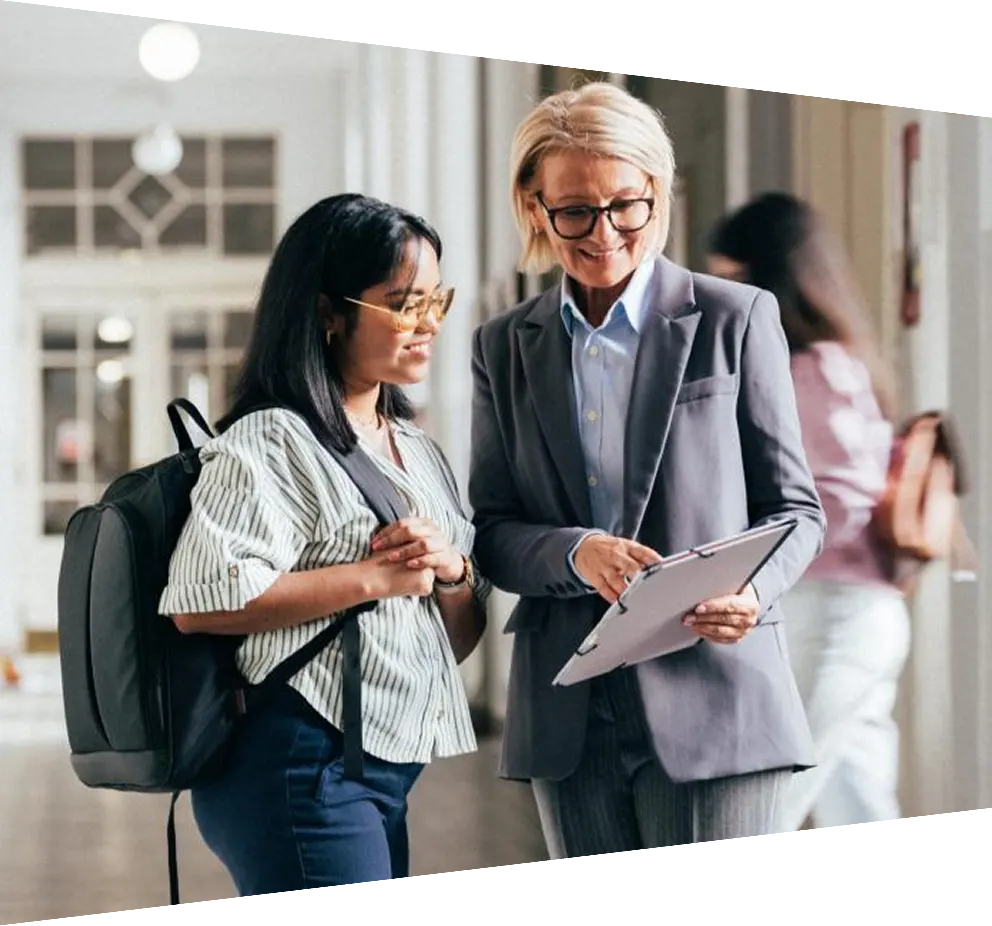 Teacher and Student Discussing Work in a School Hallway