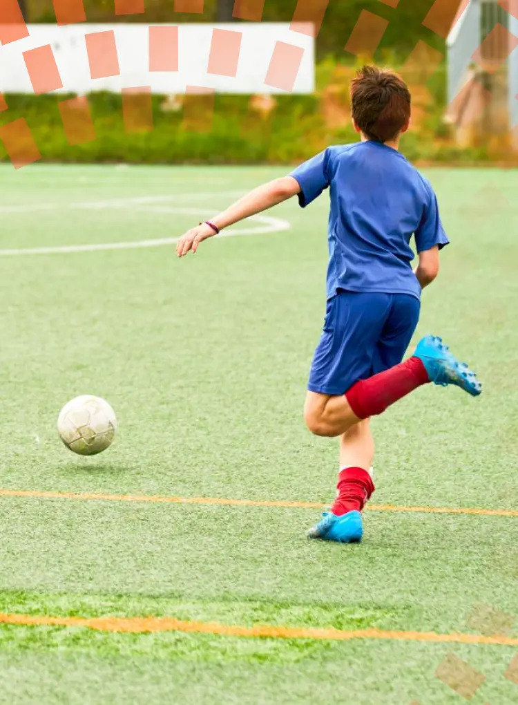 Boy on a soccer field, getting ready to kick soccerball
