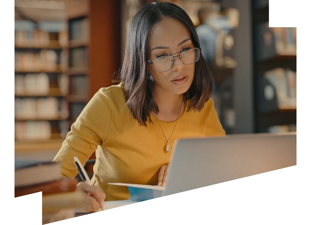Two Asian businesswomen talking while working together with laptop in a modern office startup