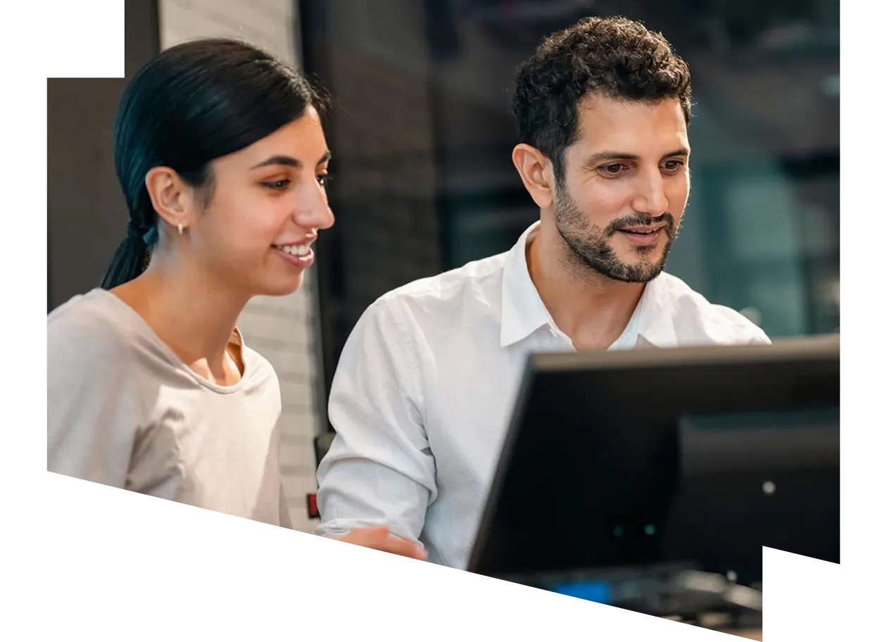 A man and a woman looking at a computer screen
