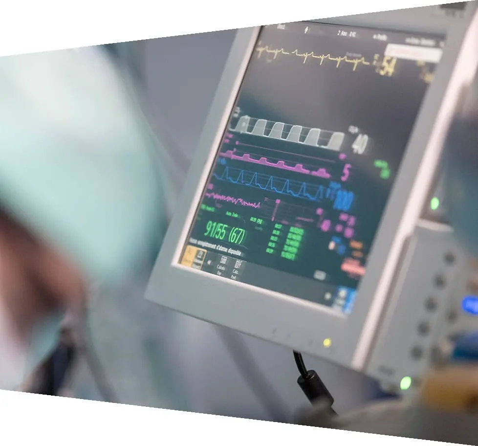 a monitoring screen shows patient data