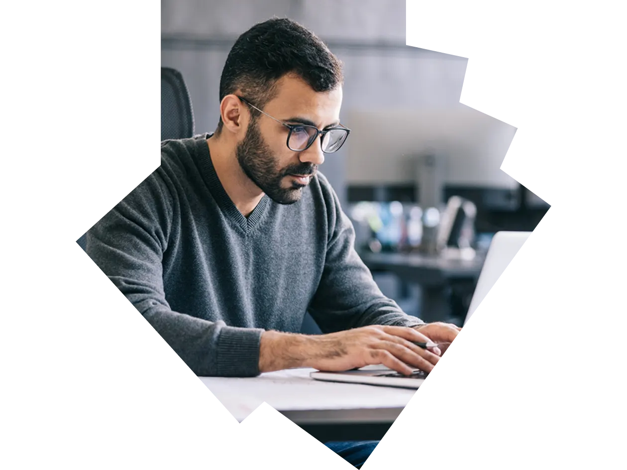 Man in sweater working at desk