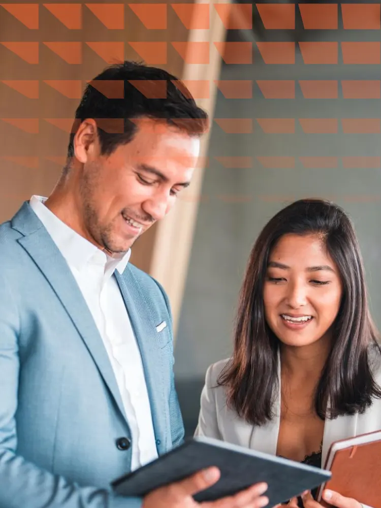 Focused male manager sharing ideas through a tablet to female intern