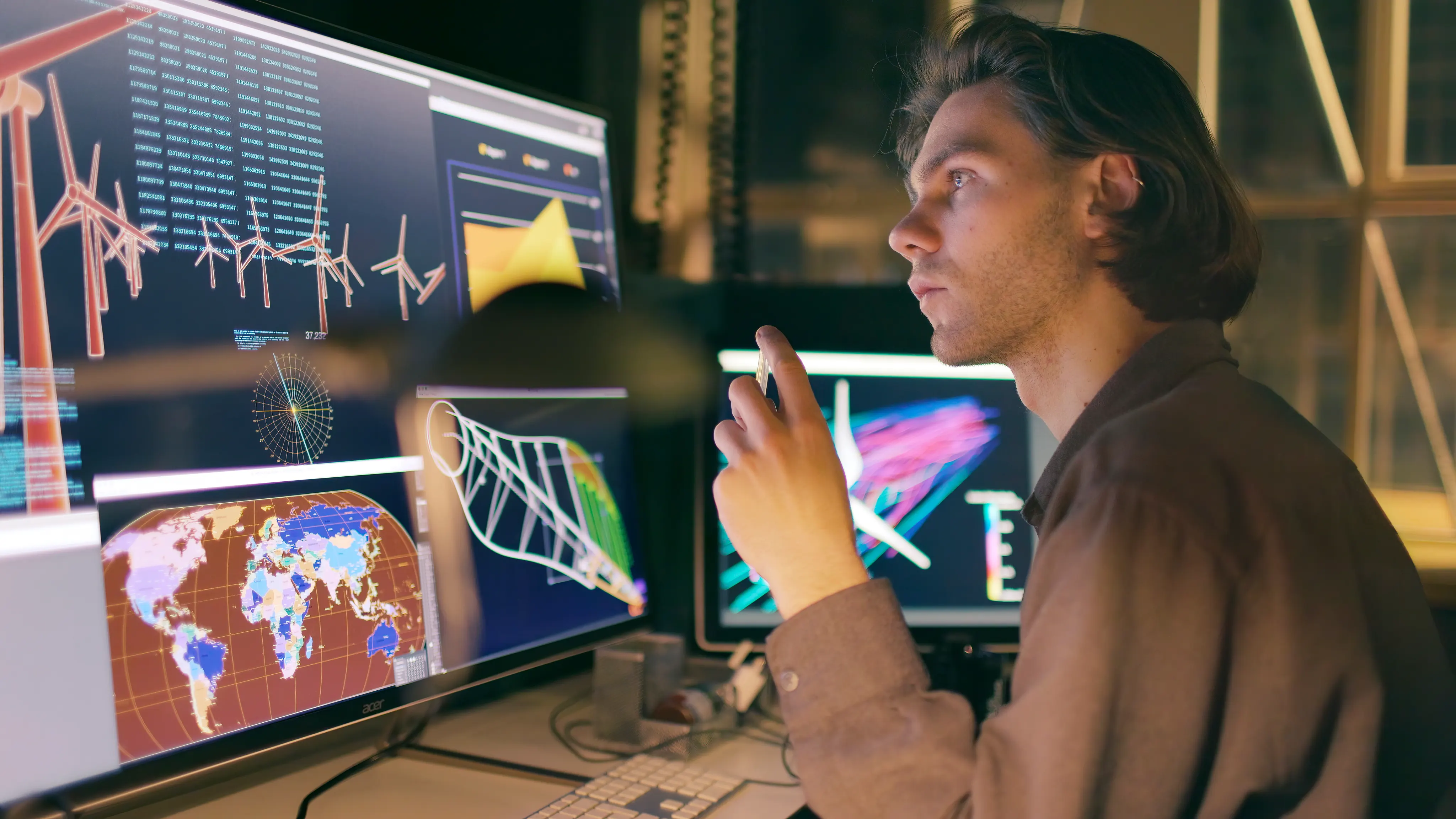 Man working on the designs for a wind turbine farm