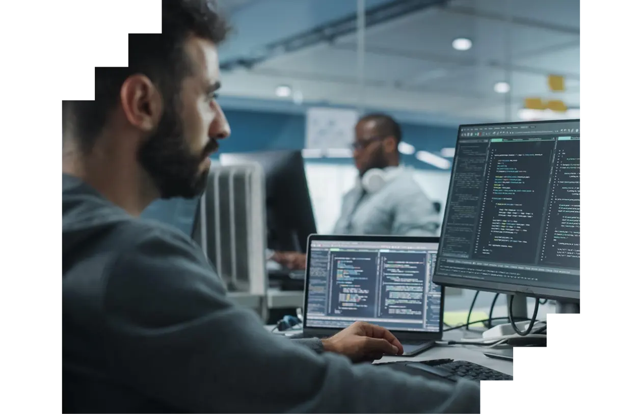 Male IT programmer writing code on desktop computer