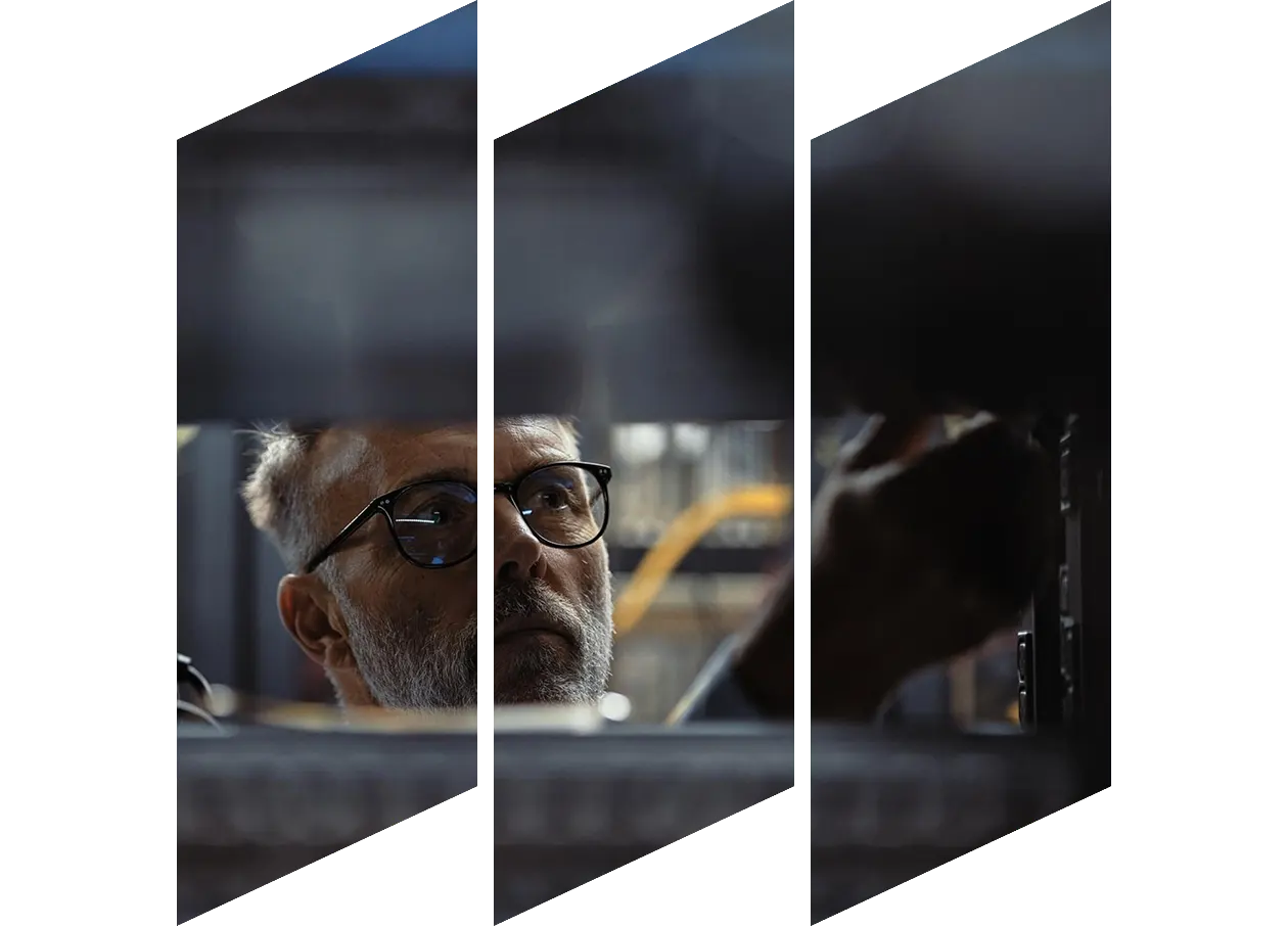 Mature IT specialist repairing hard drives in a server room