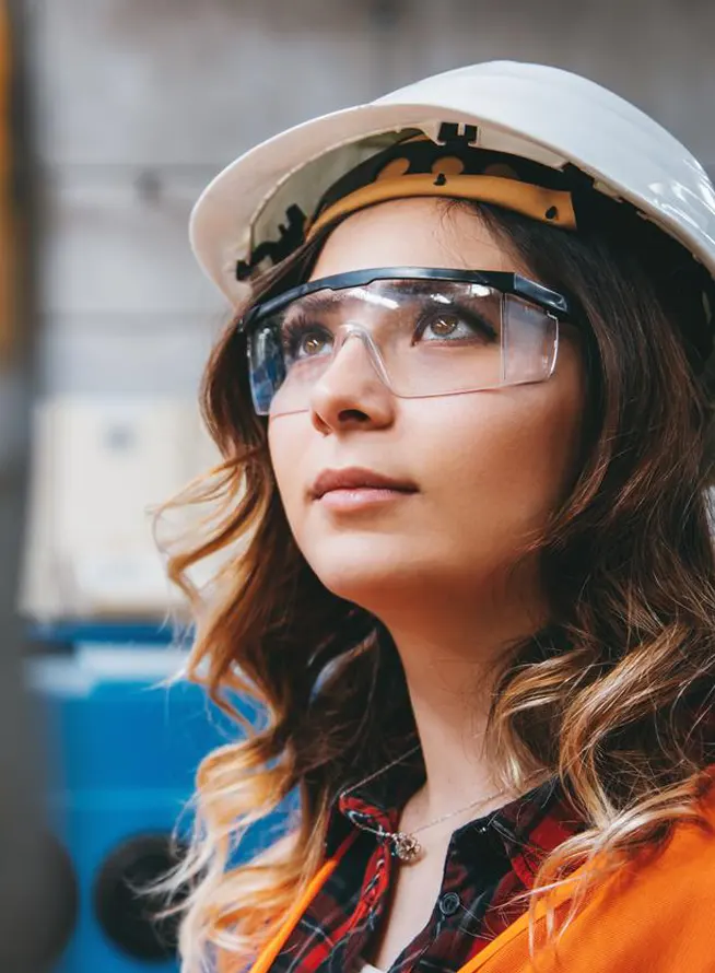 Female engineer in safety vest and hardhat