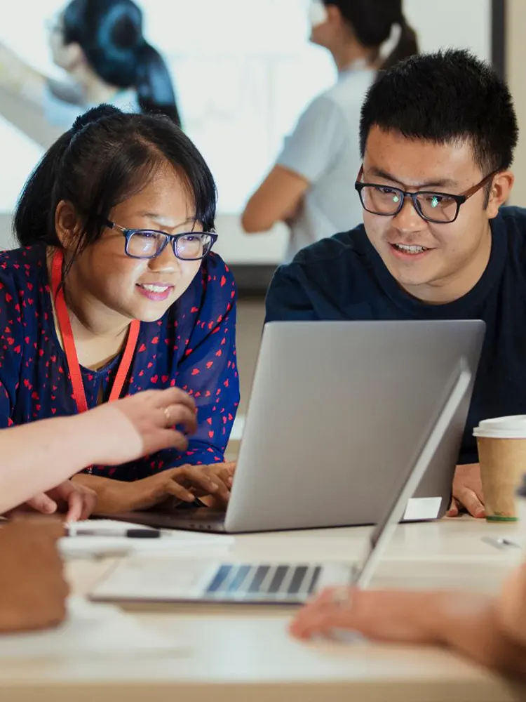 Authors sitting around a conference table talking and laughing together