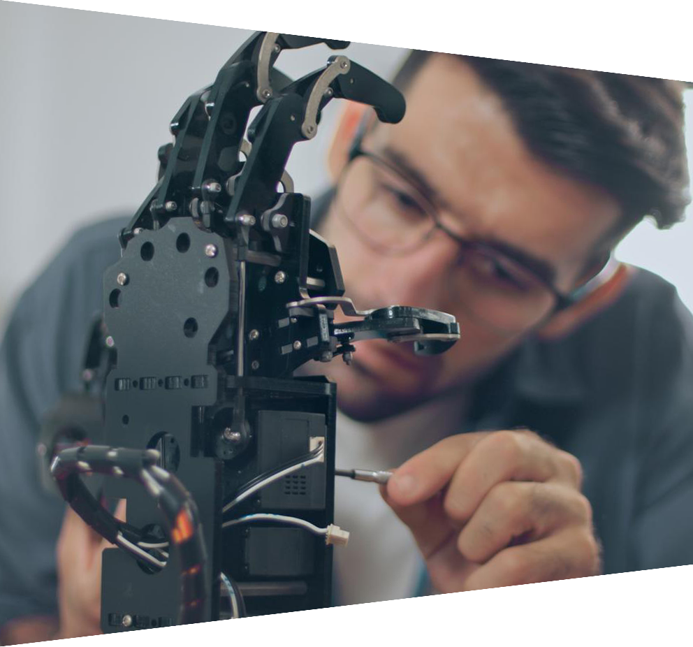 Man working on hand robot learning program