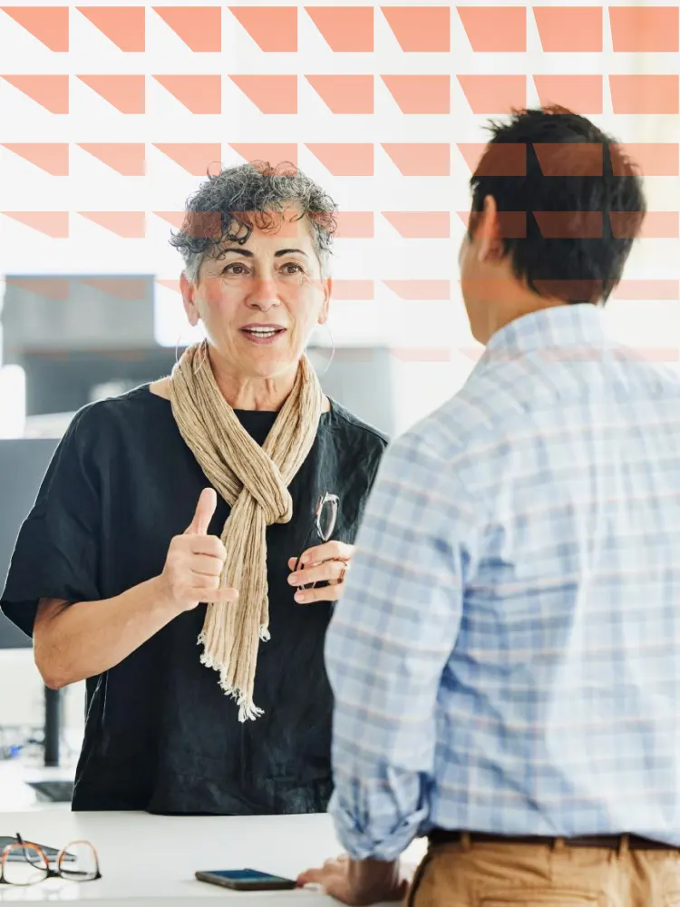 Group of young colleagues standing talking on a staircase