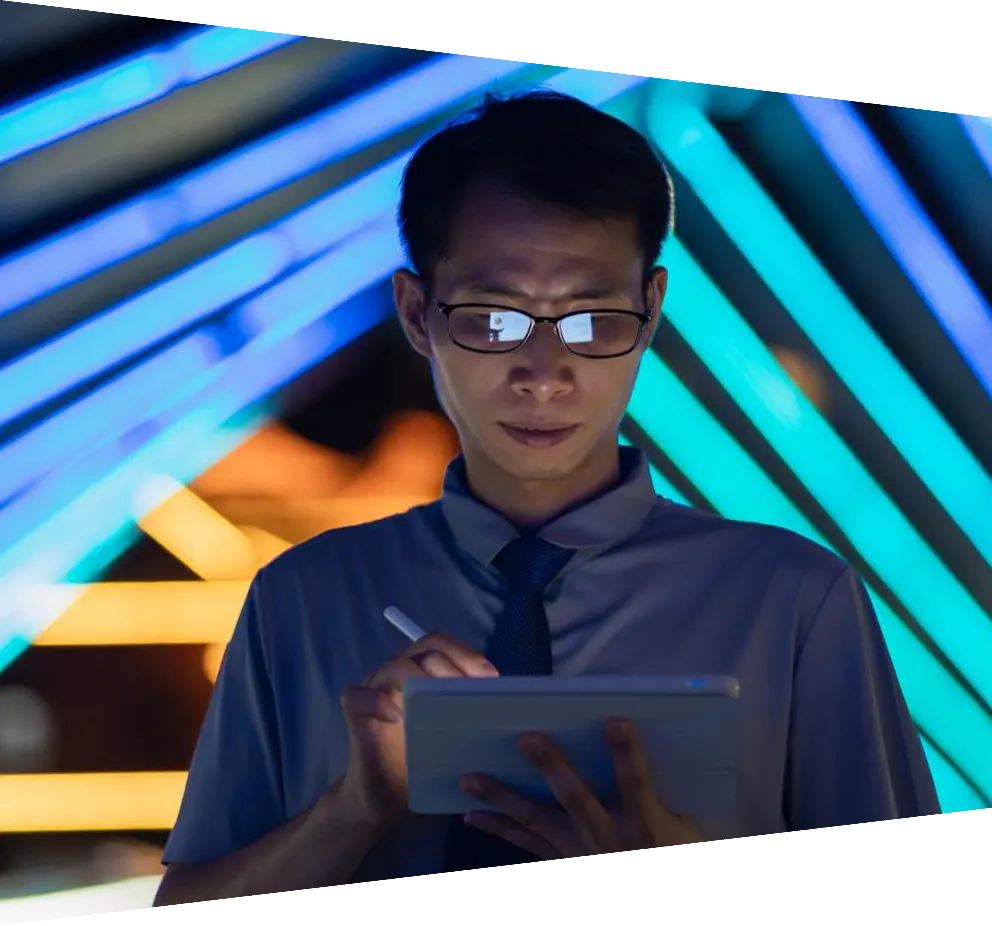 Man using tablet in front of neon background