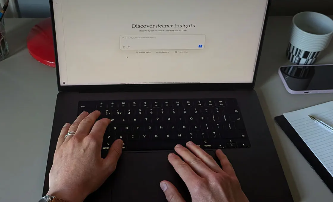 hands typing on laptop keyboard