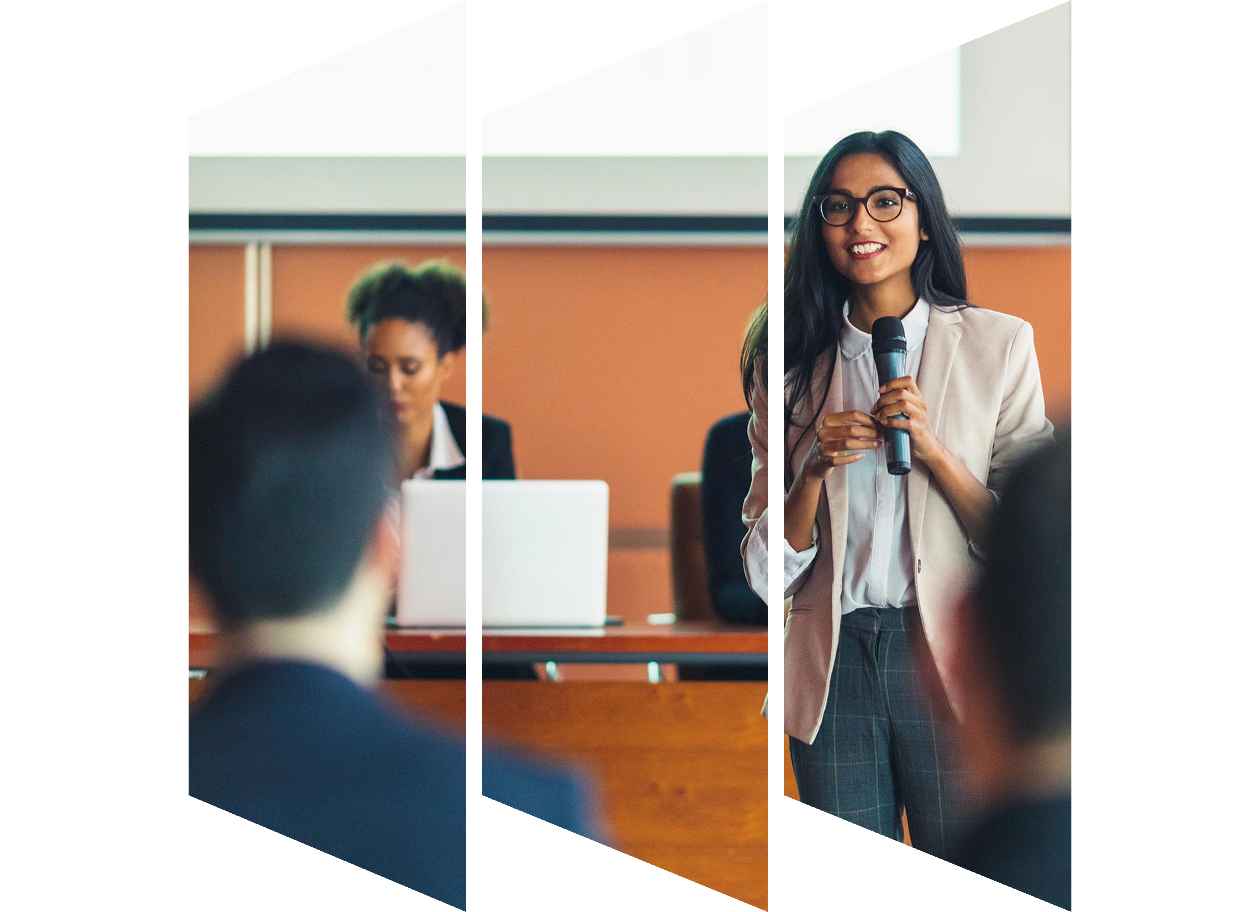 A female presenter interacting with the audience at a business presentation