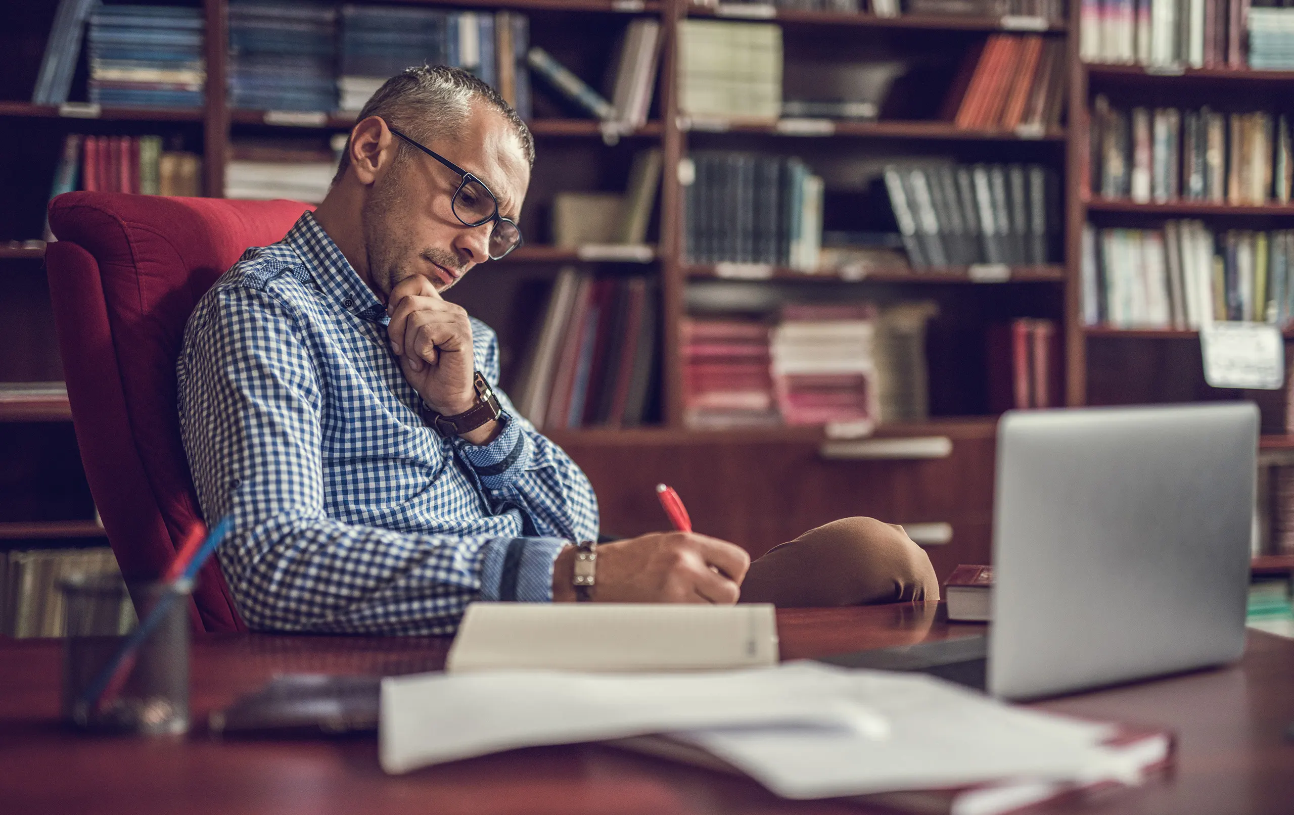 Academic leader writing down notes