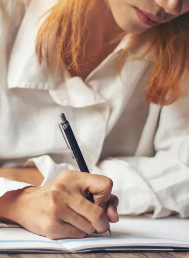 Female author making notes in her agenda
