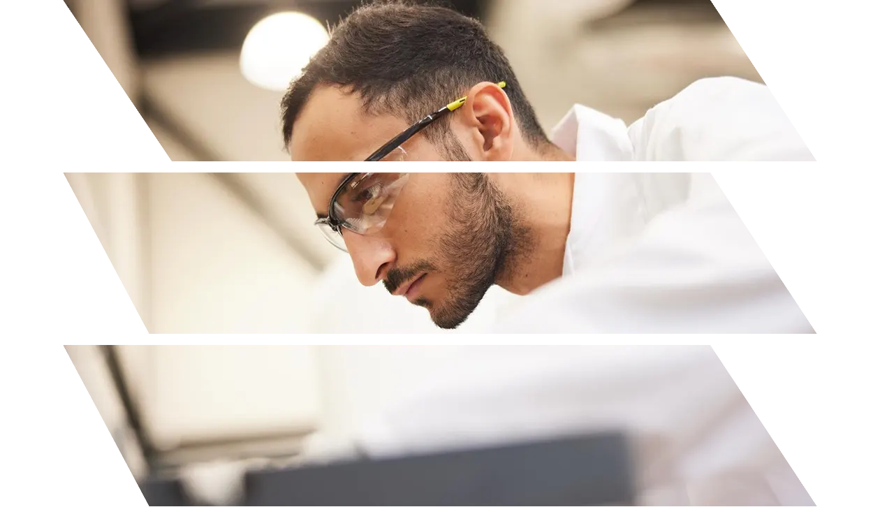 Lab worker wearing protective eyewear focusing on a task