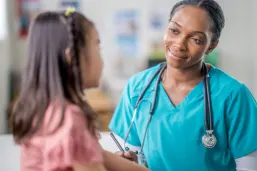 Young girl at medical appointment with paediatrician