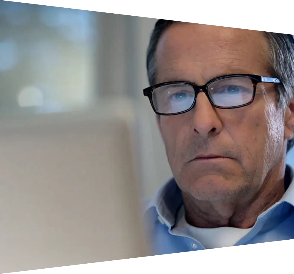 Mature man looking downwards at computer screen