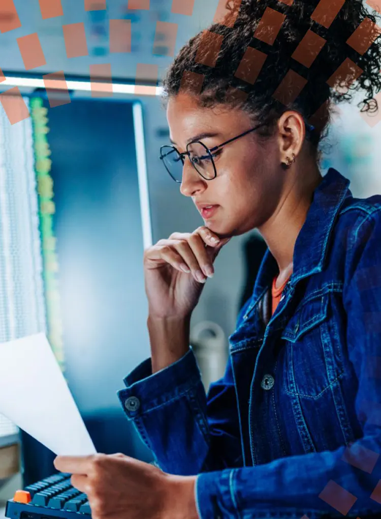 Young Latin American female software engineer reading technical document