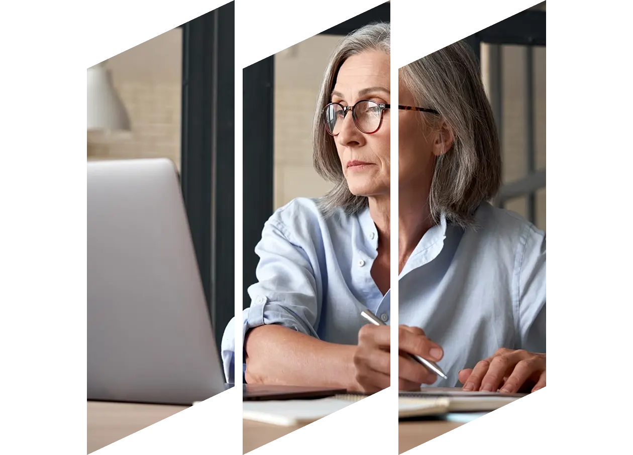 Business woman watching training webinar on laptop while working in an office