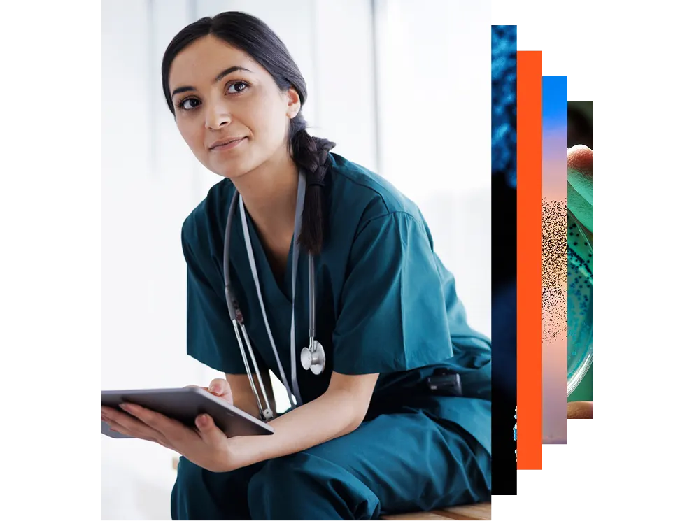 A woman in a lab coat stands with a laptop, ready to work
